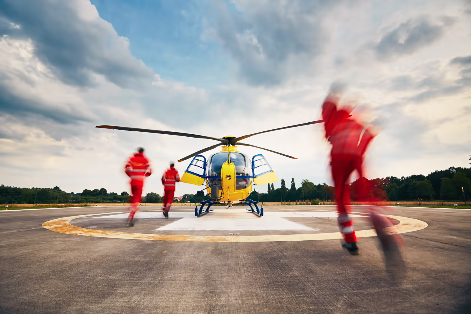 Air medical crew reviewing patient data on an EMR-integrated tablet before a transport flight