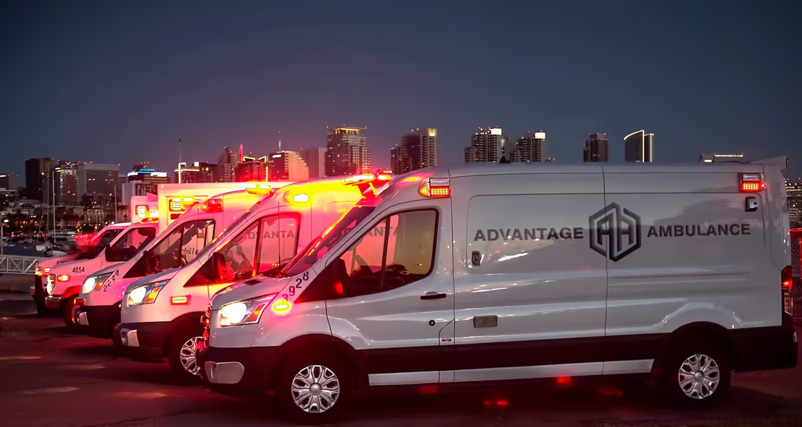 Advantage Ambulance vehicle with paramedics loading equipment outside a hospital