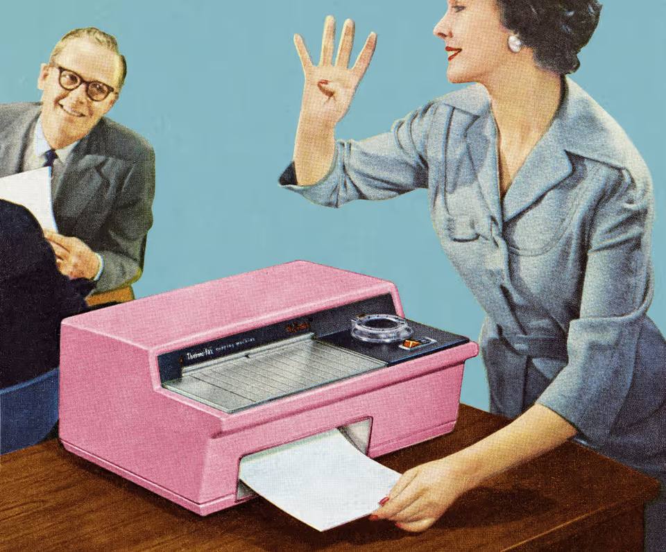 Old fax machine beside a modern digital healthcare platform interface